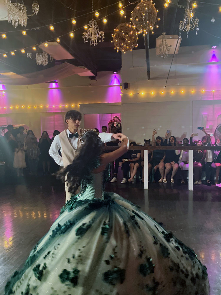Quince girl on illuninated dance floor with brother.