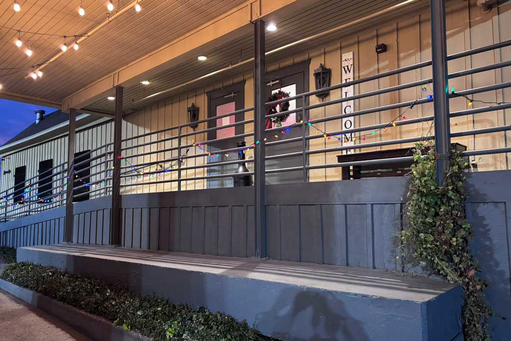 Exterior of building in evening showing the front doors and evening lighting.