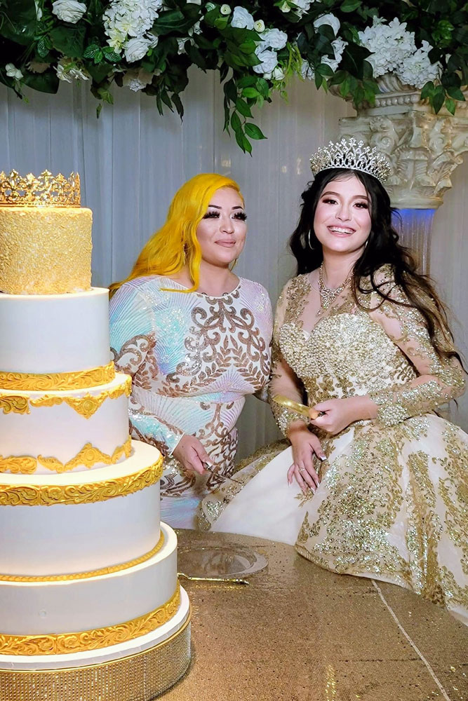 Quinceañera girl wwith mother about to cut cake during a Sweet Sixteen reception