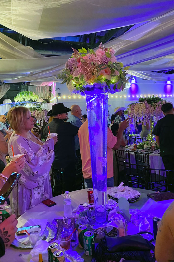 Guests networking at a corporate event with decorative lighting and elegant centerpieces