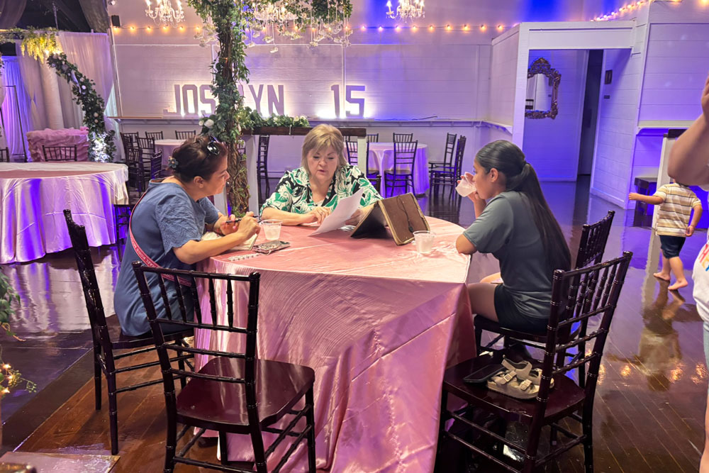 Family meeting with a Chateau salesperson to plan a quinceañera.