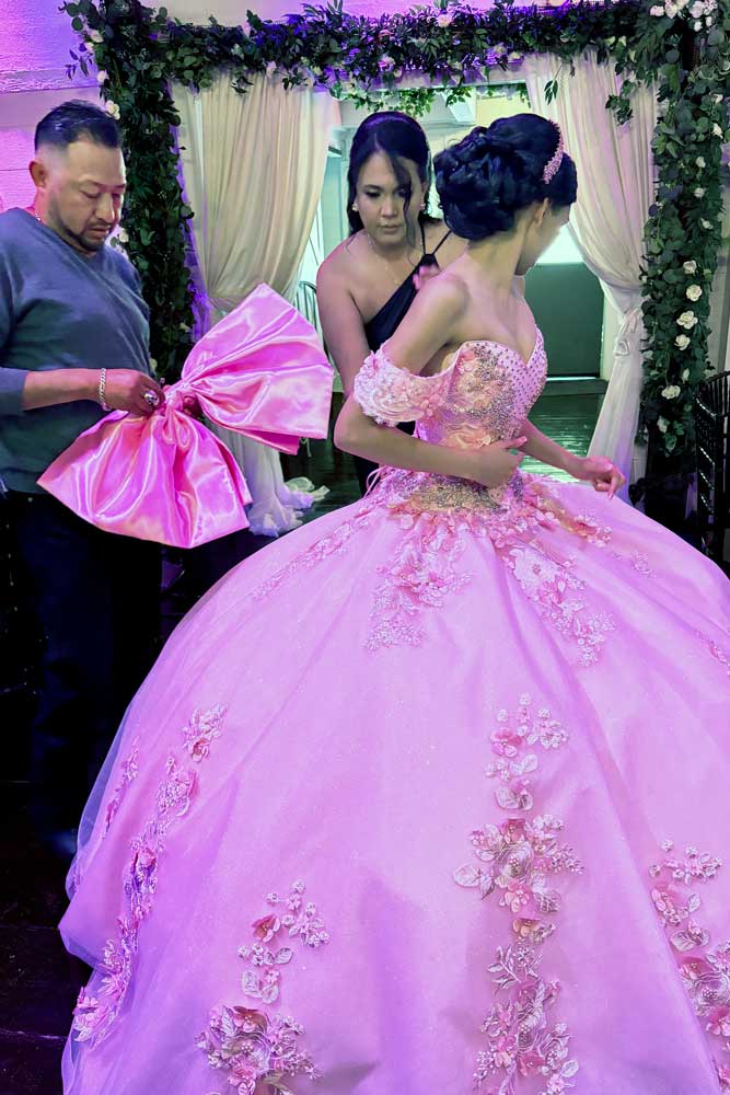 Dad helping daughter with dress moments before the party begins