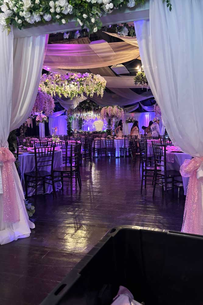 A look into the ballroom from the foyer with twinkling lights.