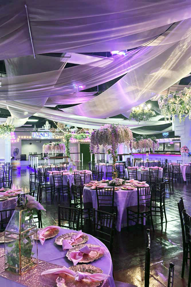 Grand Ballroom with accent lights and fully styled guest tables.