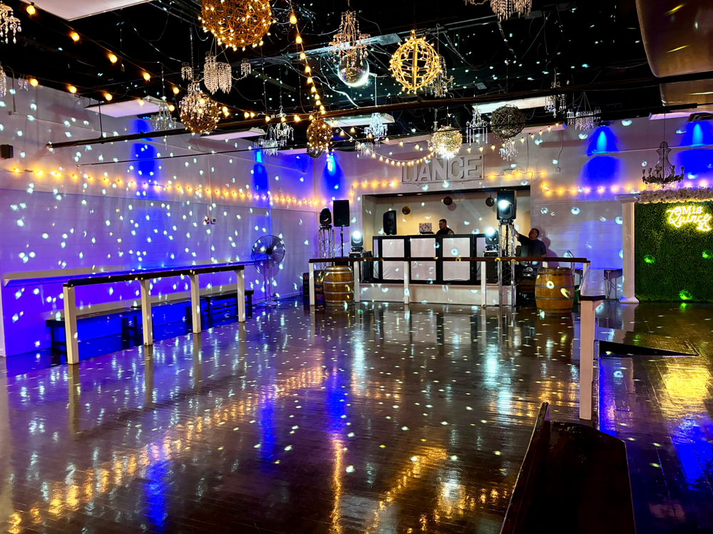 Sparkle dance floor illuminated by soft blue lighting for a romantic celebration atmosphere