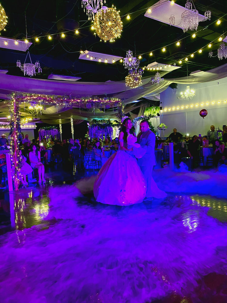 Cinderella-inspired quinceañera dance floor with chandeliers, elegant lighting, and fairytale décor