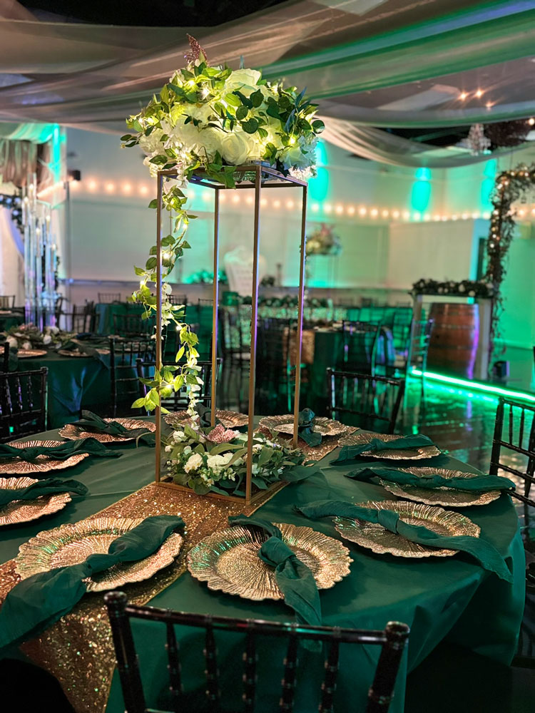 Forest-inspired tall centerpiece combining greenery, texture, and soft glow