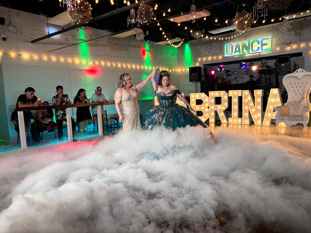 Fog filled dance floor with greenery-inspired lighting design