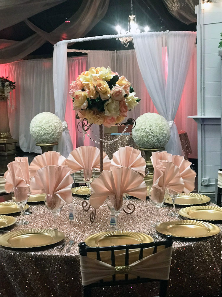 Floral centerpiece featuring blush pink flowers and elegant accents