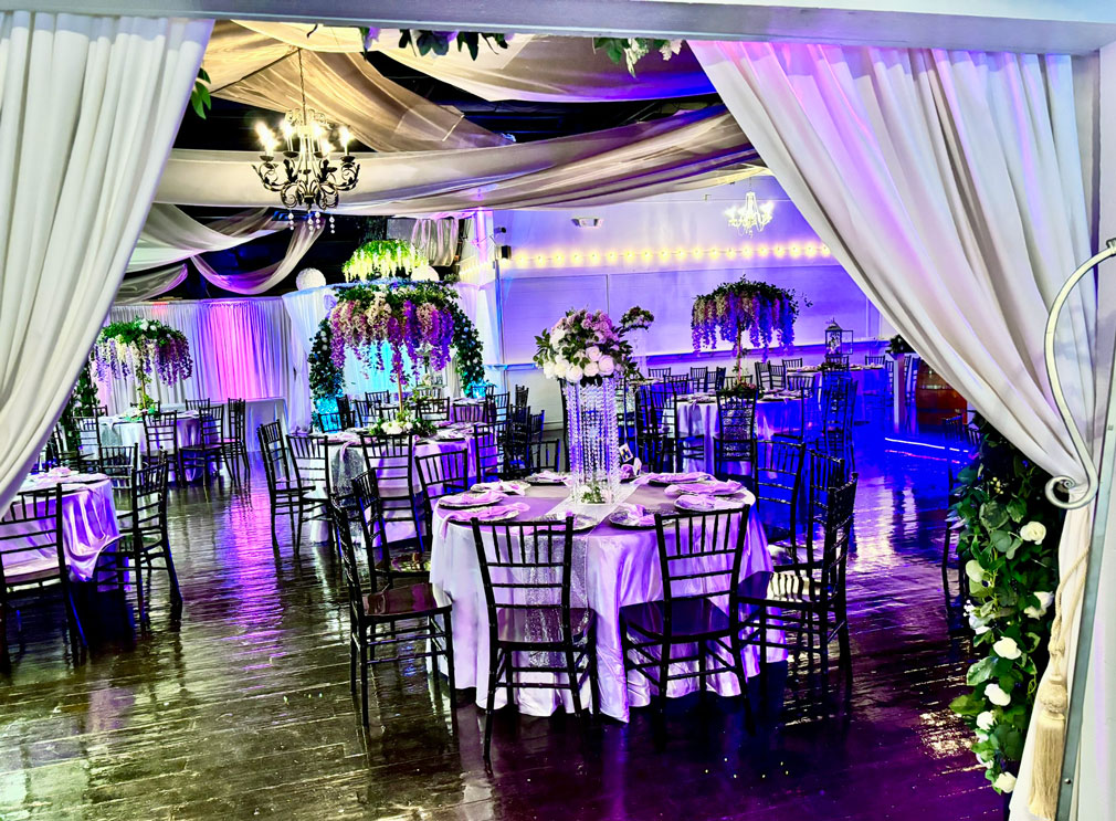 View of the grand ballroom decorated in lavender and plum tones for an elegant celebration