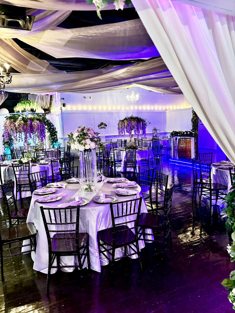 Grand ballroom decorated in lavender and plum tones for an elegant celebration