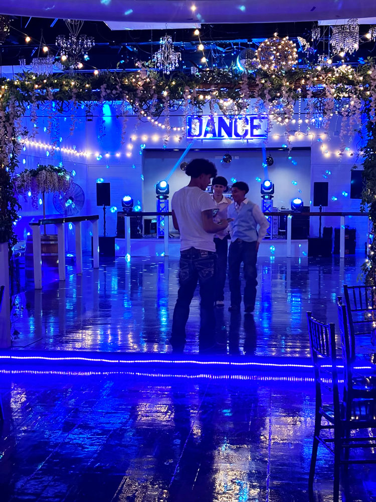Ballroom dance floor accented with vibrant lighting and dramatic ambiance