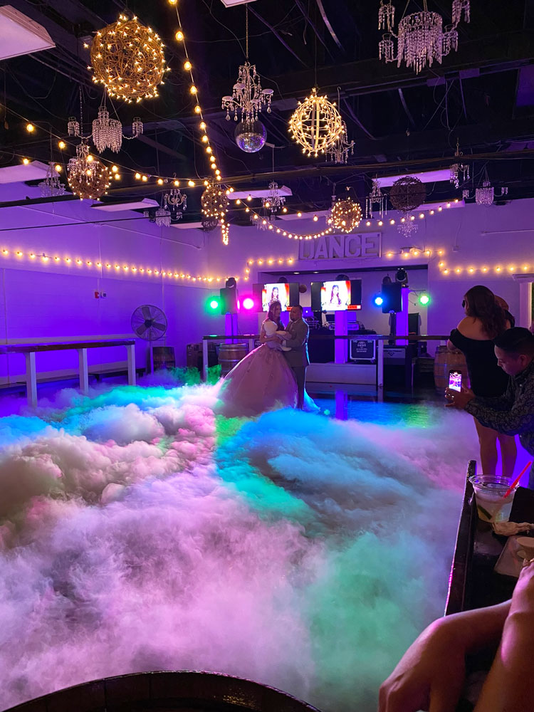 Dance floor fog with illuminated with purple lighting in an elegant event ballroom