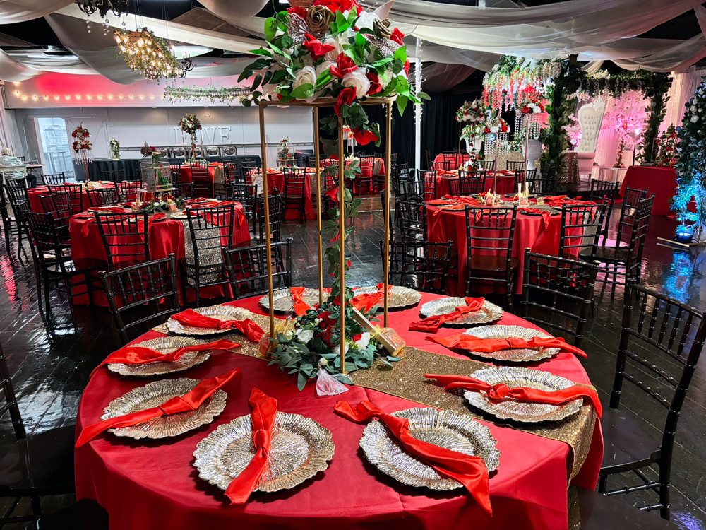 Event table centerpiece in shades of crimson and burgundy